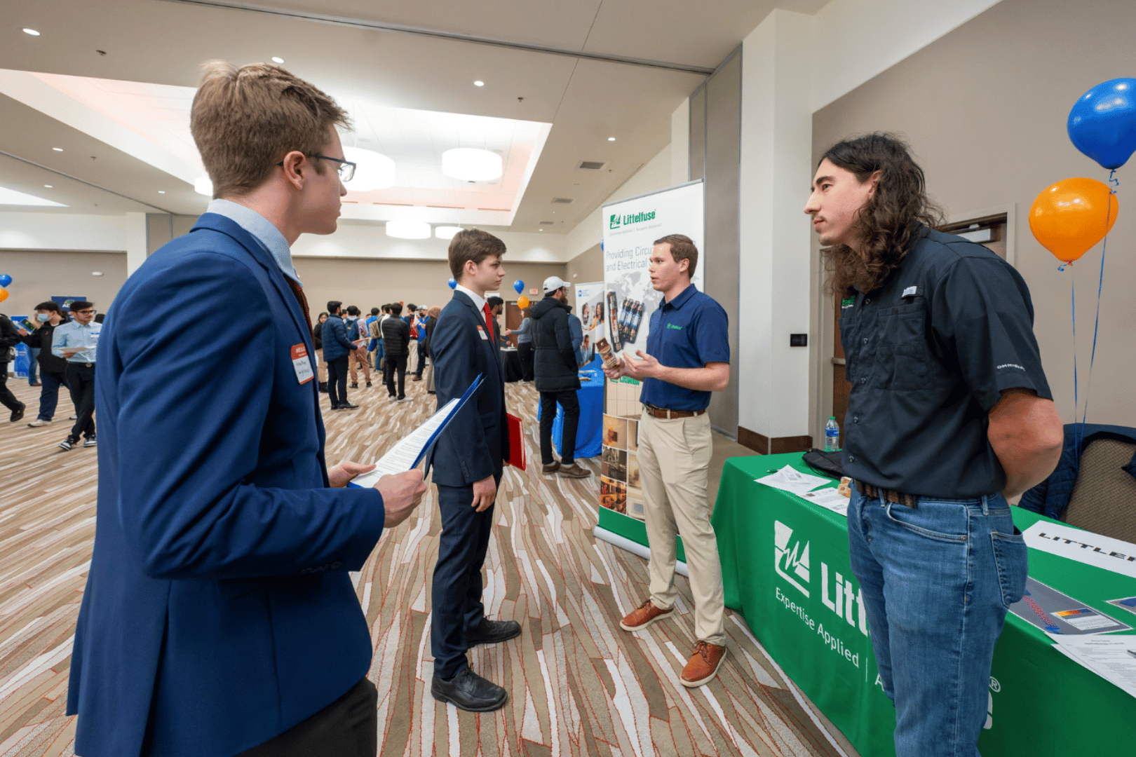 Students and recruiters conversing at Littelfuse table