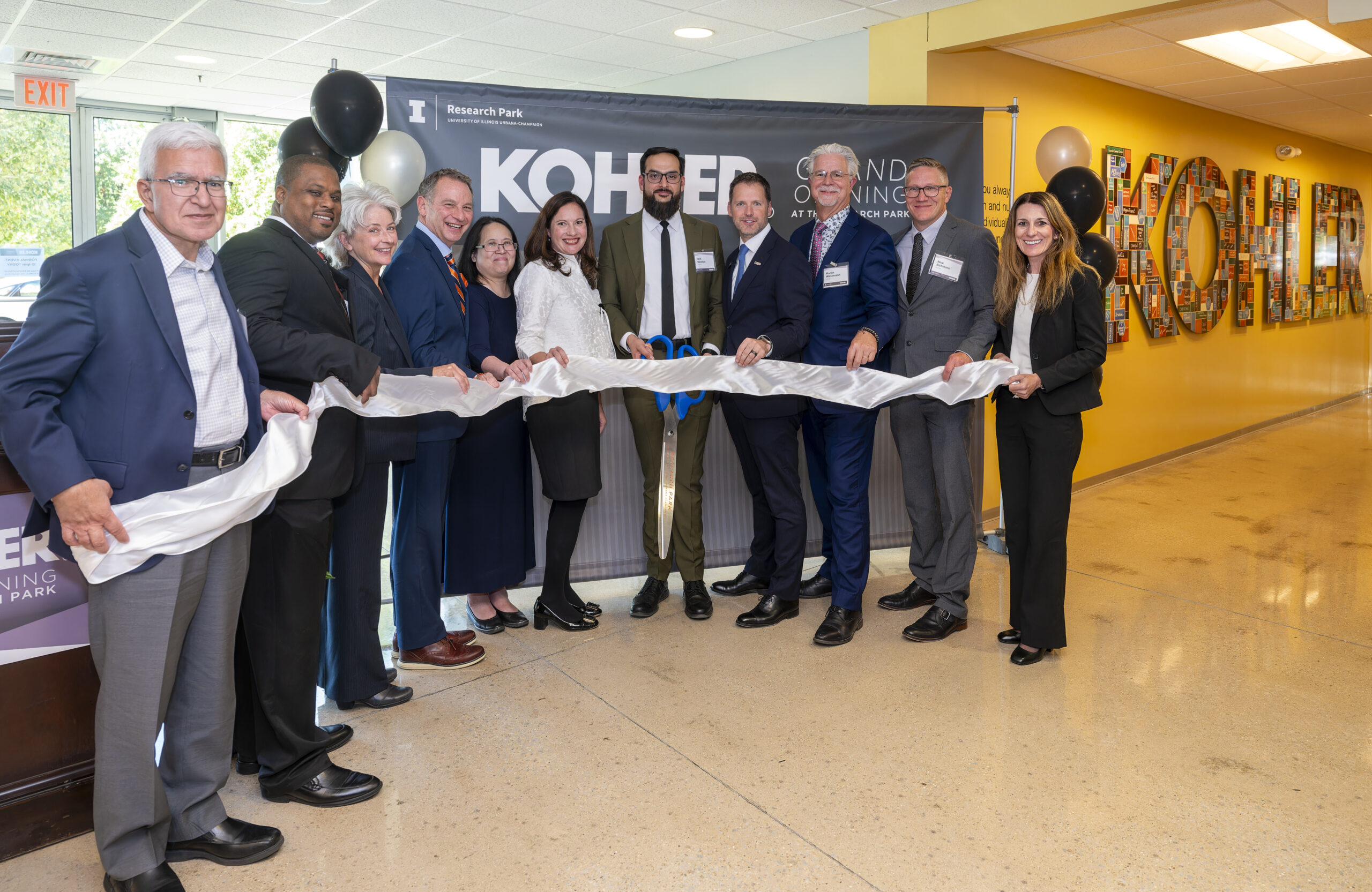 Representatives from Kohler, The University of Illinois, Research Park, and the state of Illinois pose for the official ribbon cutting for the Kohler Innovation Center.