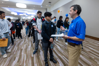 Students speaking with Motorola Solutions recruiter