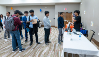 Students waiting in line and speaking to Yummy Future recruiter