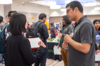 Student showing resume to John Deere recruiter