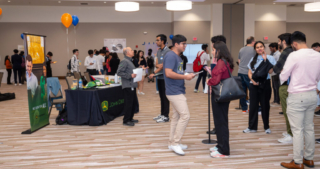 Students speaking with John Deere recruiters